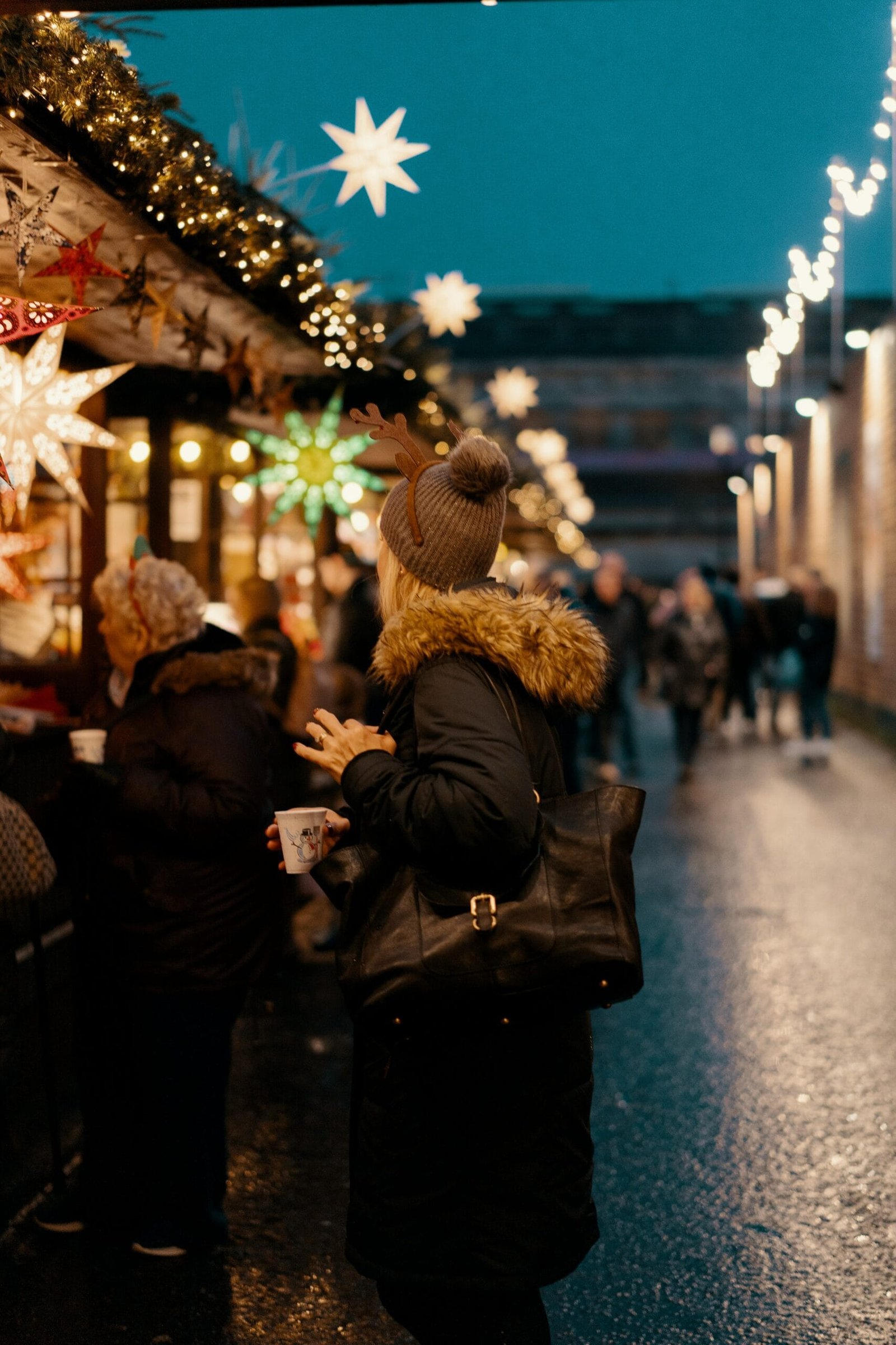 woman in black and - NewsOk woman in black and brown furlined coat standing facing store