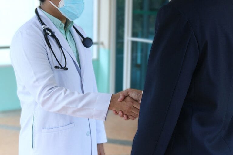 Photo by herbert11timtim - NewsOk doctor, patient, handshake