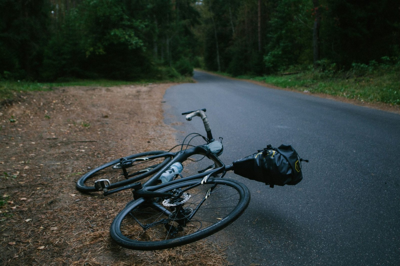 black road bike lying - NewsOk black road bike lying on asphalt road during daytime